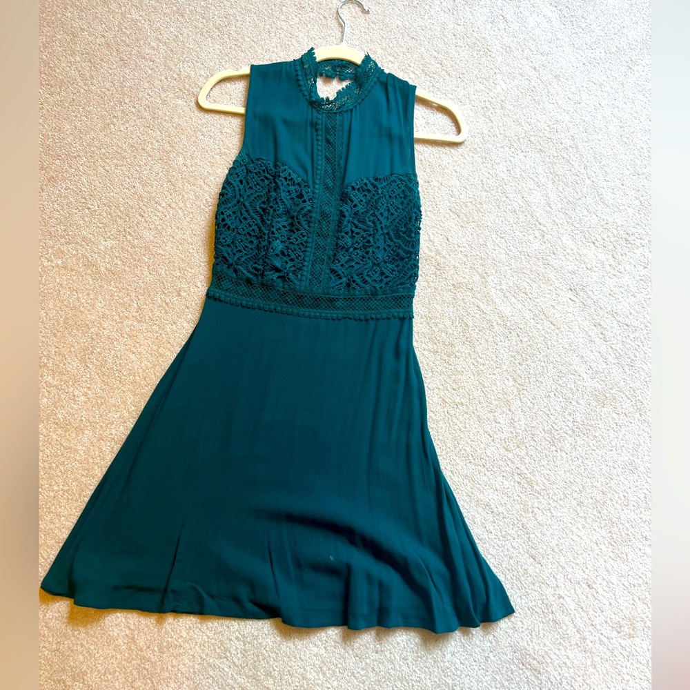 Francesca’s teal high neck dress